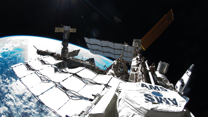 Photo of exterior view of the International Space Station, taken by NASA astronaut Ron Garan during a spacewalk conducted on July 12, 2011. The photo shows the space station with a Fisheye Camera and the curvature of Earth below. (NASA)