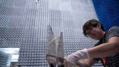 A radar engineer works on a test antenna for the SkyFall mission’s ground-penetrating radar in the electromagnetic interference chamber at JPL. (Nasa.gov)