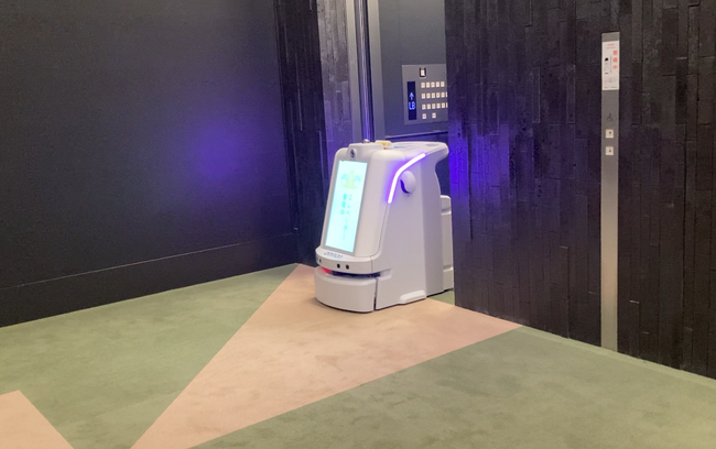 東京都「西新宿先端サービス実装・産官学コンソーシアム　先端サービス実装分科会プロジェクト」における、建物設備とロボットの連携に関する実証実験の実施と今後の展開について